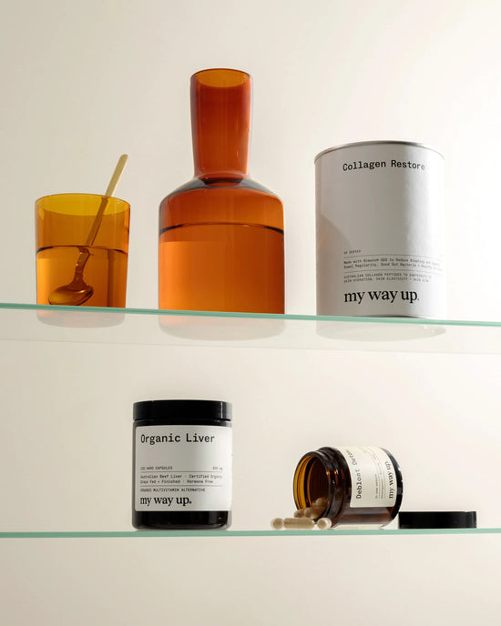 Glass shelf with various 'my way up' products including bottles and containers.